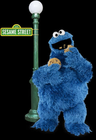 A Blue Puppet Holding Cookies And Standing Next To A Green Pole