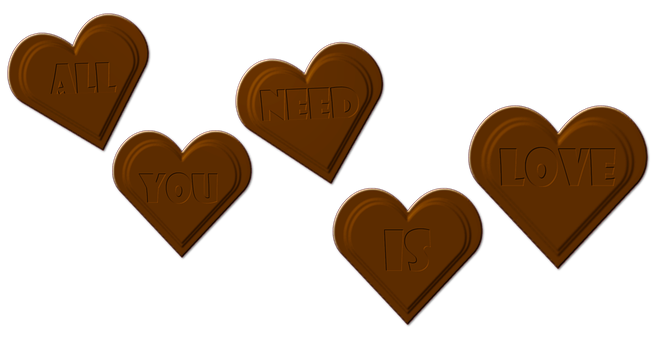A Group Of Chocolate Hearts With Words Carved Into Them