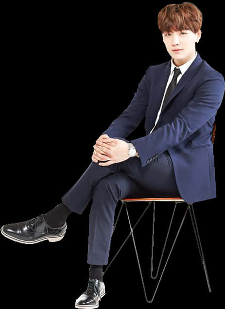 A Man In A Suit Sitting On A Chair PNG