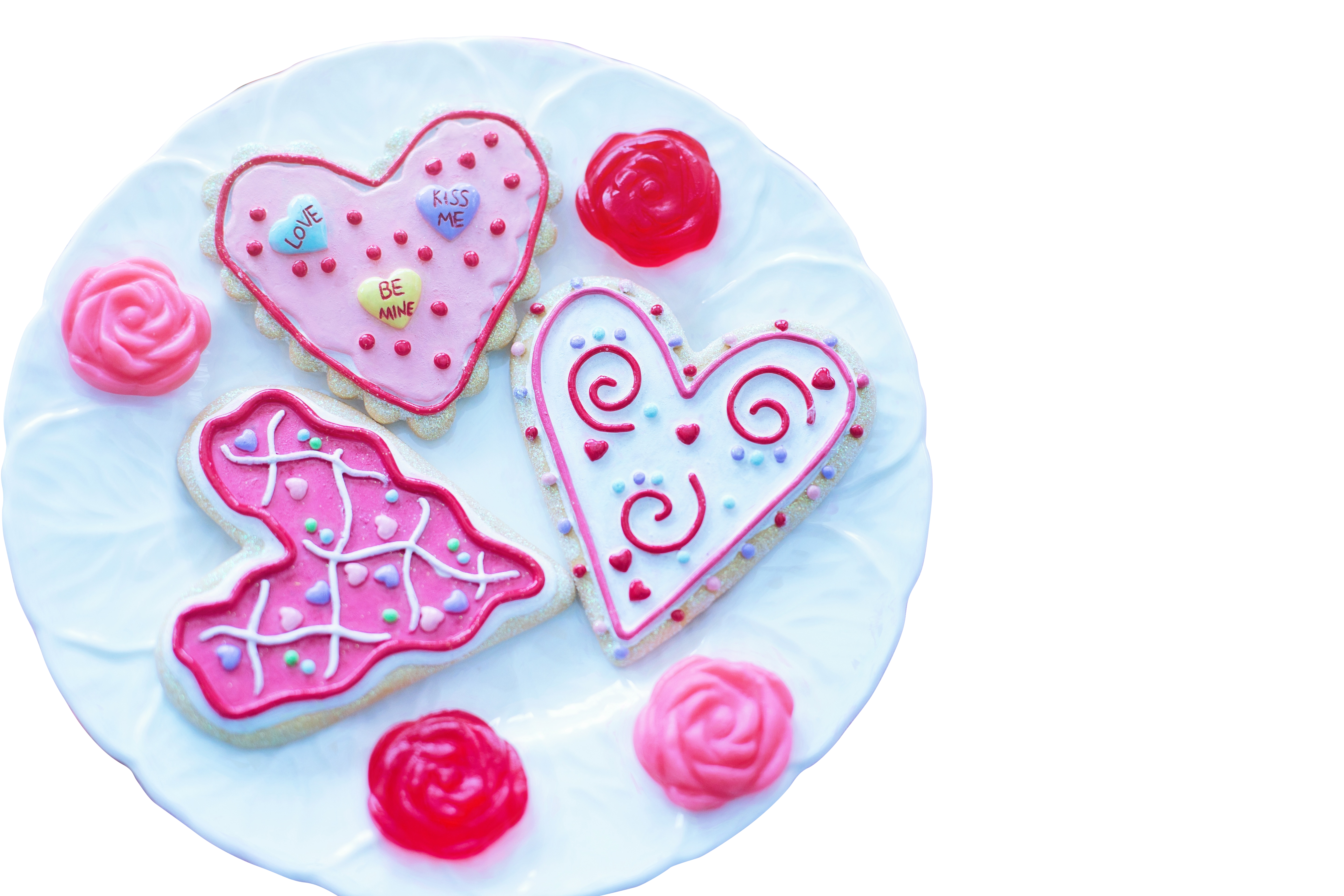 A Plate Of Cookies With Pink Frosting PNG