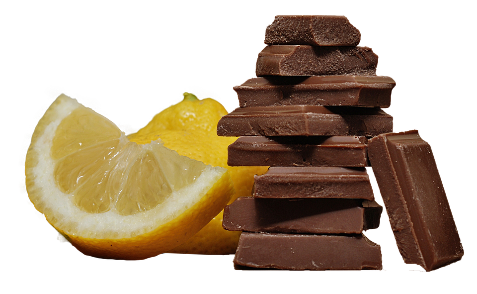 A Stack Of Chocolate And A Lemon PNG