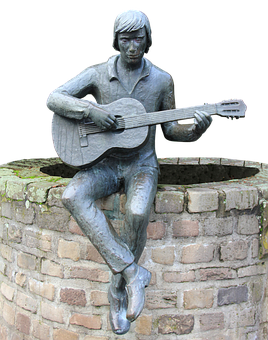 A Statue Of A Man Playing A Guitar
